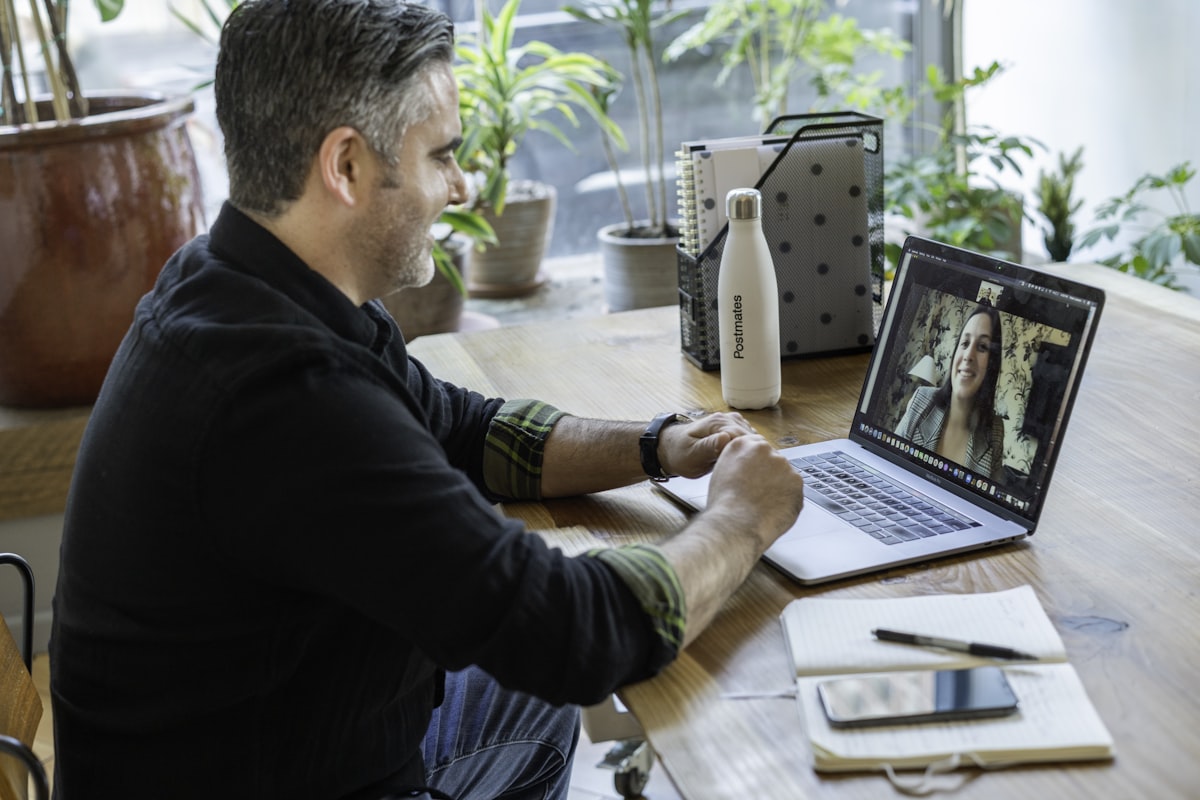 Trader joining a live online session from a laptop